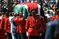 Military officers carried the coffin, which was draped with the national flag