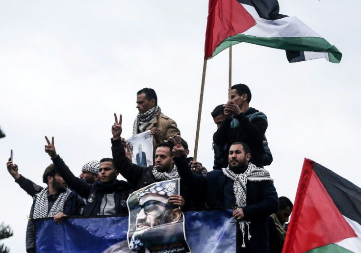 Palestinian protesters in Gaza City hold up portraits of president Mahmud Abbas and late Palestinian leader Yasser Arafat ahead of Abbas' appearance at the UN Security Council