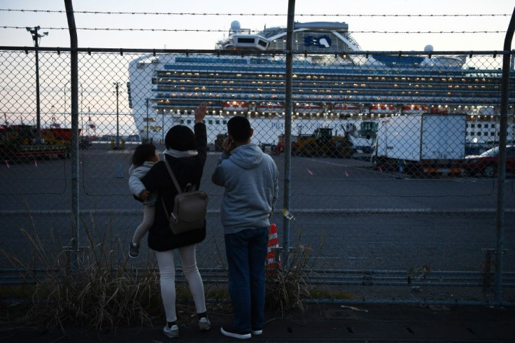 Relatives of passengers wave towards the Diamond Princess cruise ship, quarantined off Japan, which has the biggest cluster of COVID-19 cases outside of China