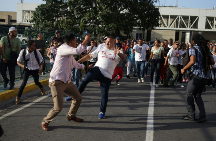 Fighting broke out between supporters of Guaido and Maduro as the opposition leader was leaving the airport