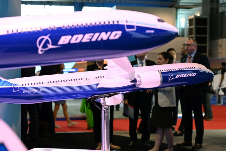 Visitors look at Boeing 787 and 777 models on display at the Singapore Airshow