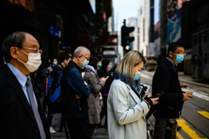Hong Kong pedestrians wear face masks as a preventative measure against the COVID-19 coronavirus. The virus has spooked markets around the world, having killed more than 1,100 people and infected tens of thousands