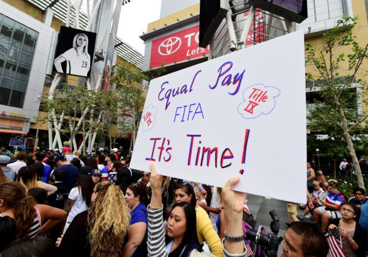 A US women's soccer fan displays a sign calling for equal pay at a rally to celebrate last year's US title run at the Women's World Cup