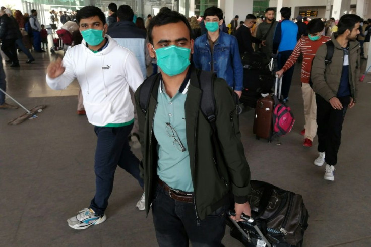 Pakistani students wearing protective face masks arrive from China at Islamabad International Airport. Pakistan is one of the few countriers to maintain flights to China during the crisis