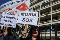 Dozens of demonstrators from the Aegean islands of Lesbos, Chios and Samos gathered outside the interior ministry, brandishing banners against the camps project