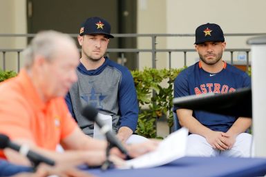 Altuve (R) and Bregman watch as team owner Crane apologizes for the sign-stealing scandal