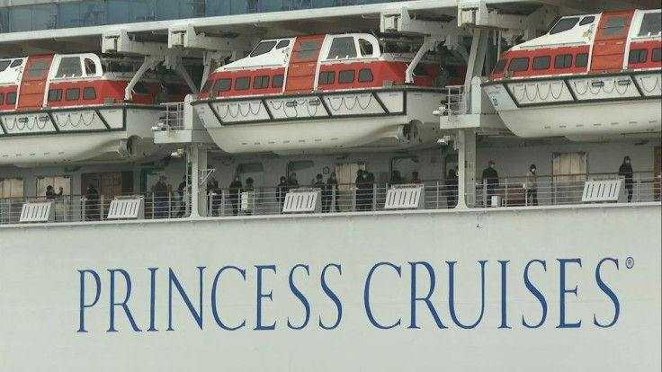 IMAGESPassengers are seen walking on the deck of the quarantined Diamond Princess cruise ship in Japan on Friday. The vessel has become the single largest cluster of cases outside China, with 218 testing positive for the COVID-19 virus as of Thursday and 