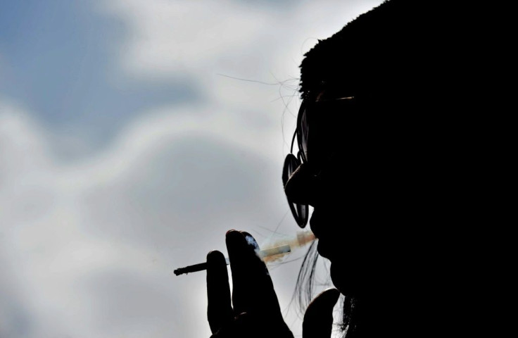 Saudi woman Heba smokes a cigarette at a cafe in Riyadh