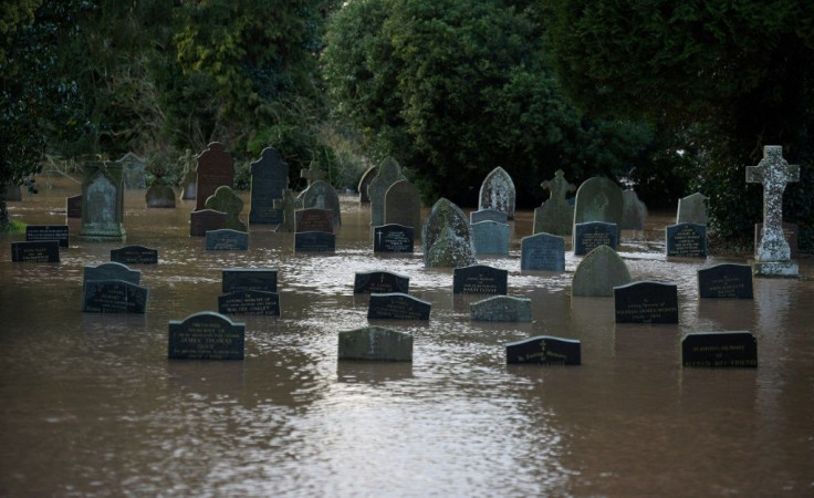 Flood water surrounds tomb stones at a graveyard in Tenbury Wells, after the River Teme burst its banks in western England