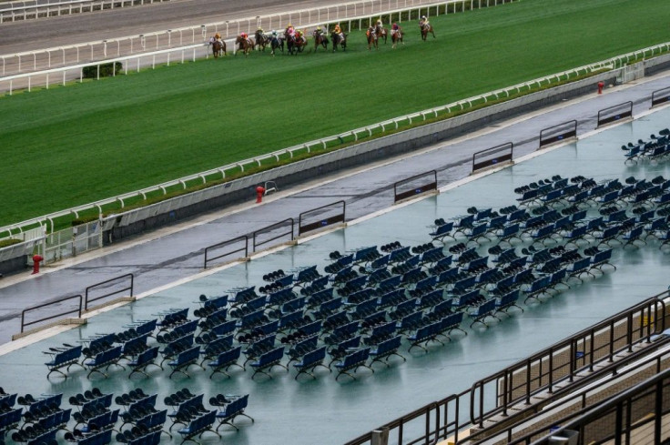 Team Spirit ridden by Tony Piccone heads the field past empty grandstands before going on to win the eighth race at Hong Kong's Sha Tin racecourse on Sunday