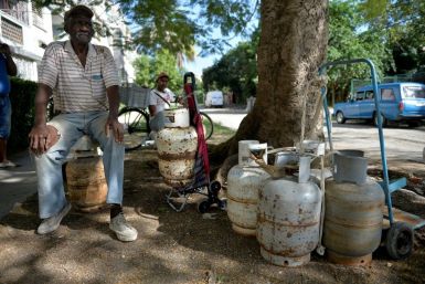 A man waits to replace an empty propane gas drum in Havana, on January 14, 2020: the Communist island is facing widespread fuel shortages in the wake of new US sanctions
