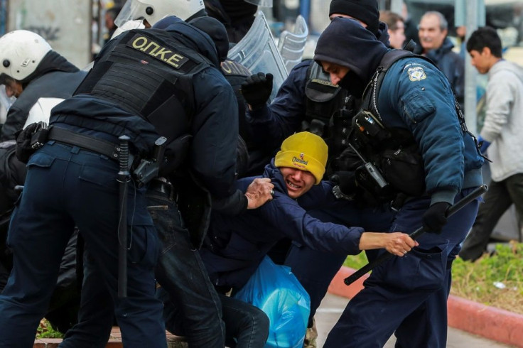 Riot police scuffle with migrants during a demonstration outside the municipal theatre of the city of Mytilene, on the island of Lesbos, on February 4, 2020.