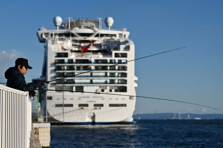 A fisherman tries his luck near the Diamond Princess cruise ship at the Daikoku Pier Cruise Terminal in Yokohama port