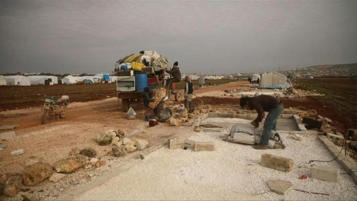 Displaced families prepare to flee a camp for internally displaced people, east of Sarmada in the north of the northwestern Idlib province, amid an ongoing pro-regime offensive.