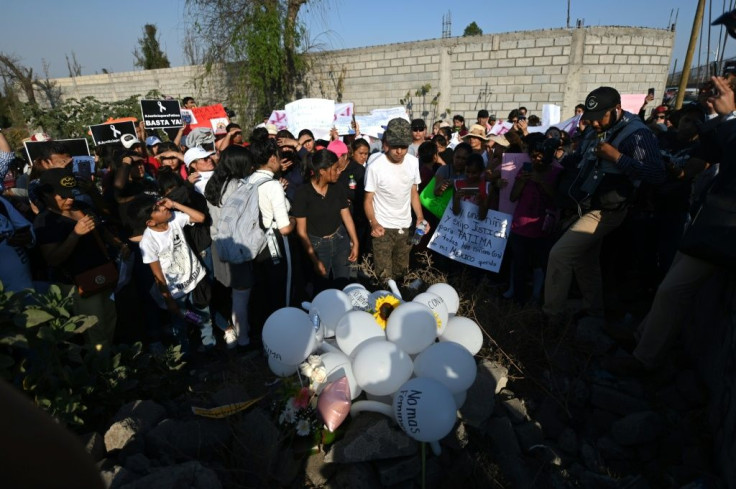 People lay white balloons and flowers at the site where the body of a seven-year-old girl was found over the weekend with signs of torture in Mexico City