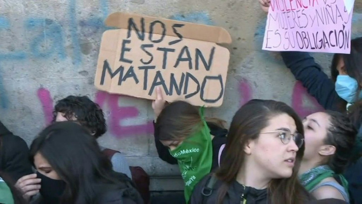 A group of protesting Mexicans chant to denounce violence against women in front of their country's National Palace, after a seven-year-old girl was murdered in the Mexico City.
