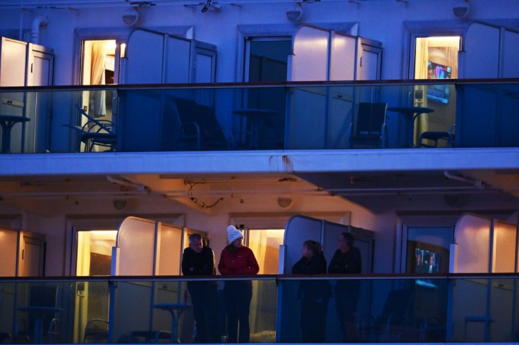 Diamond Princess passengers stand on the cruise ship's balconies on February 18