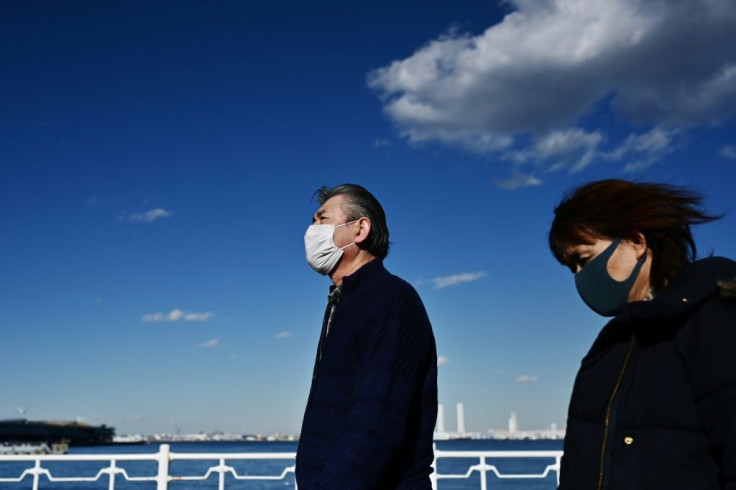 People walk by the coast in Yokohama on February 18