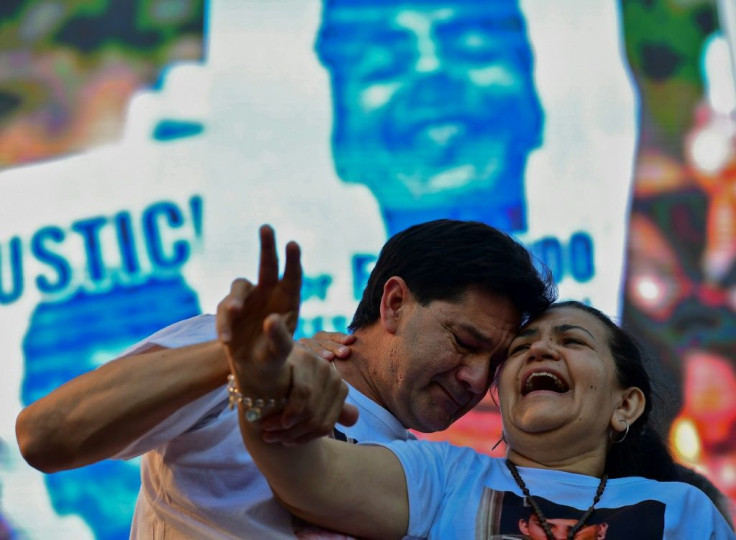 Silvino Baez (L) and Graciela Sosa (R), parents of Fernando Baez, at Tuesday's rally outside the Congress building in Buenos Aires