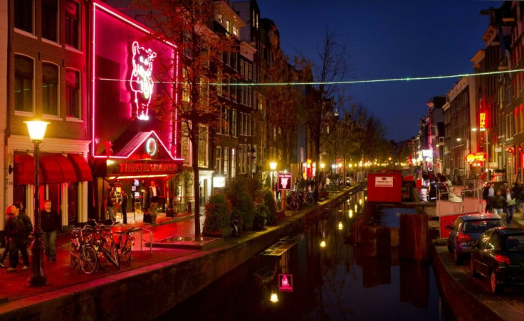Amsterdam is looking at moving part of its famed red light district (pictured 2011) to an indoor complex that could include a bed and breakfast for prostitutes as well as a sex club, sex theatre and cafes