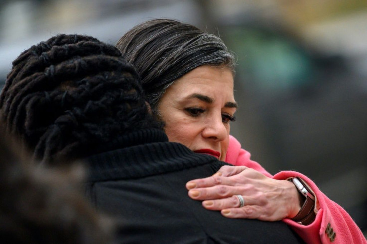 Parisa Dehghani-Tafti comforts the daughter of a murder victim, who she meets outside the courthouse in Arlington, Virginia