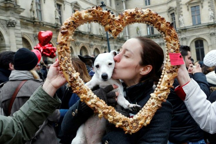 True love: a woman and her Valentine's Day date pose behind a heart-shaped pastry during a February 14 Paris flash mob