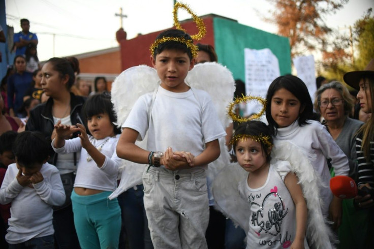 Children attend the burial in Mexico City of the  seven-year-old girl whose body was found over the weekend with signs of torture on February 18, 2020