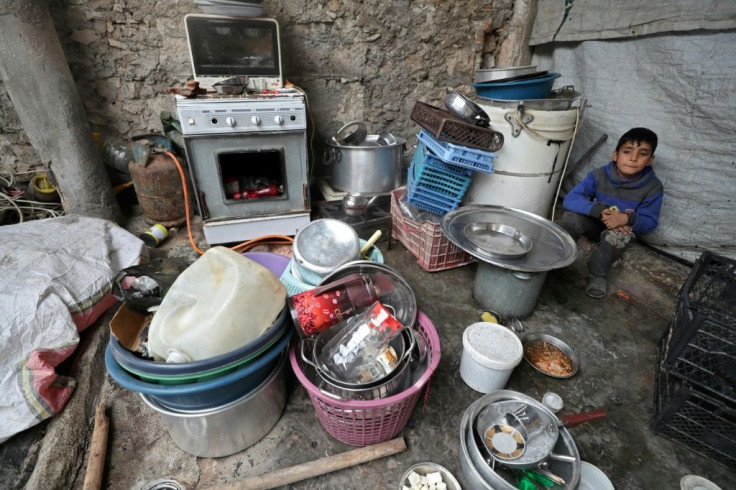 A single-room workshop in the Syrian town of Daret Ezza has been home to Abu Mohammed's family since they fled the advance of government troops on their home village a month ago but the sound of shelling signals it is time to hit the road again