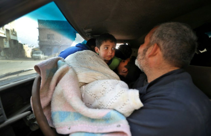 Father and children take to the road in search of safer shelter closer to the Turkish border, without knowing where they will sleep next