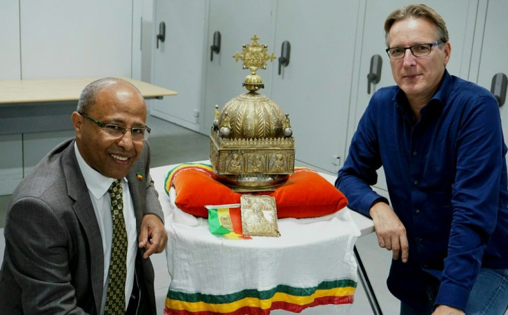 Dutch-Ethiopian Sirak Asfaw, left, and art detective Arthur Brand pose with the crown at a high-security facility in the Netherlands in September last year