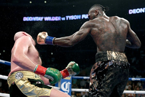 Deontay Wilder knocks down Tyson Fury in their first fight in Los Angeles in December 2018