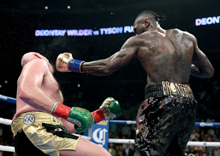 Deontay Wilder knocks down Tyson Fury in their first fight in Los Angeles in December 2018