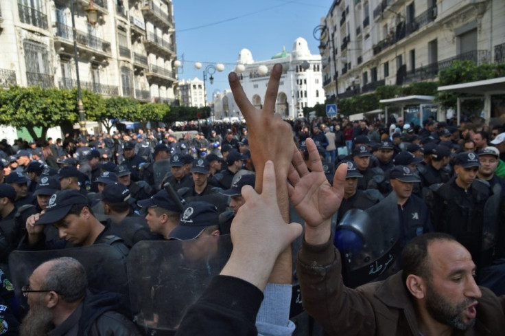 Algerian security forces encircle an anti-government demonstration in Algiers on February 18