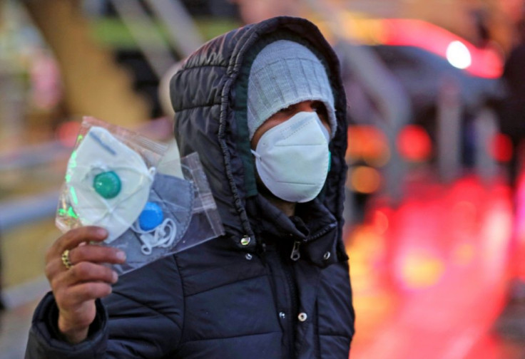 An Iranian street vendor sells protective masks in the capital Tehran