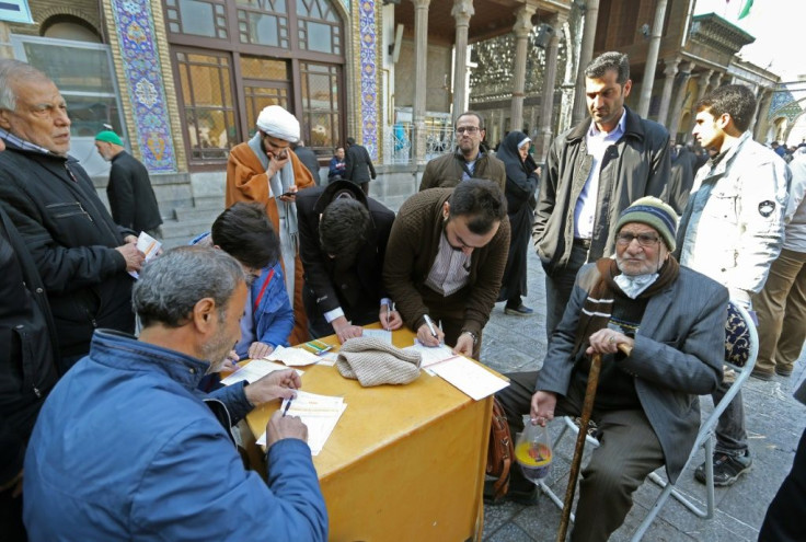 Iranians cast their votes during parliamentary elections at the Shah Abdul Azim shrine on the southern outskirts of Tehran on Friday
