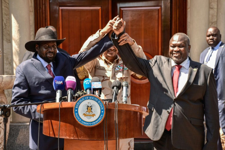 Hands together: South Sudan President Salva Kiir, left, and rebel leader Riek Machar in Juba on December 17 last year