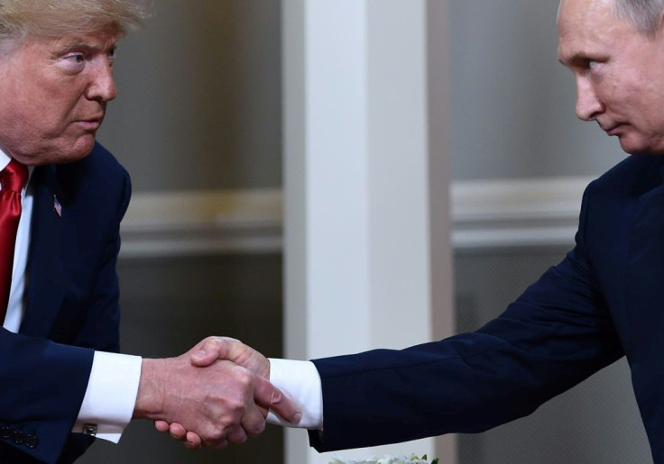 US President Donald Trump and Russian President Vladimir Putin shake hands ahead a meeting in Helsinki in July 2018