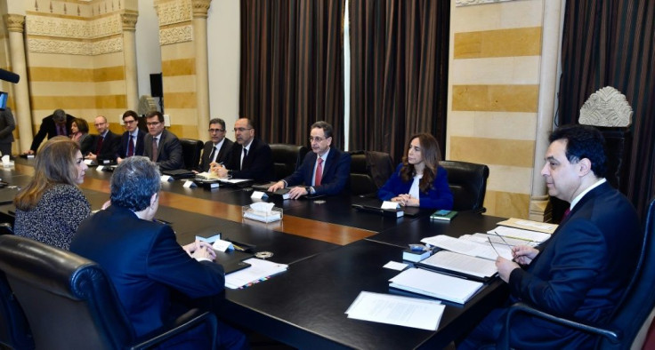 A handout picture provided by the Lebanese photo agency Dalati and Nohra on February 19, 2020 shows Prime Minister Hassan Diab (right) meeting with a delegation from the International Monetary Fund (IMF) in Beirut
