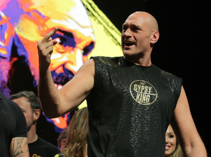 British fighter Tyson Fury gestures towards American champion boxer Deontay Wilder during their weigh-in at the MGM Grand hotel in Las Vegas, Nevada