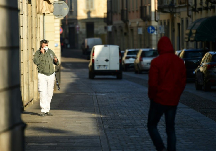 A resident wearing a protective mask in a street of Codogno, southeast of Milan. An Italian man became the first European to die after being infected with the coronavirus just hours after 10 other towns were locked down following a flurry of new cases.