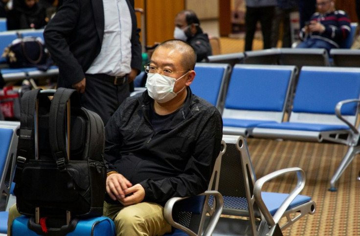 A passenger concerned about the new coronavirus wears a mask at the airport in the southern Iraqi city of Basra