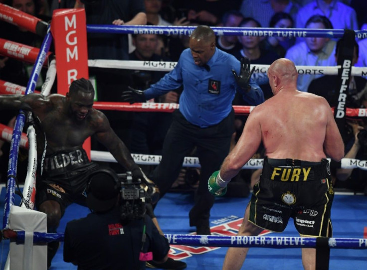 British boxer Tyson Fury, right, knocks American  Deontay Wilder down before stopping him in the seventh round during their World Boxing Council heavyweight championship fight in front of a crowd of 15,800 at the MGM Grand Garden Arena in Las Vegas