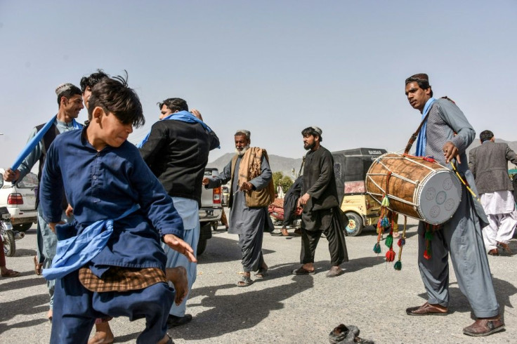 Afghans dance as they celebrate the first day of a "reduction in violence" agreement between the Taliban, US and Afghan forces in Kandahar