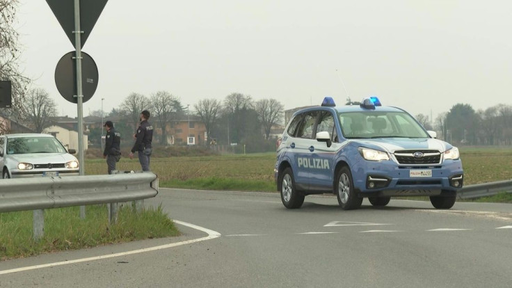 IMAGES Police cars patroll the area and install a checkpoint at the entrance of Casalpusterlengo, Lombardy, northern Italy. Tens of thousands of Italians are preparing for a week-long quarantine in the country's north as nerves begin to fray among the loc