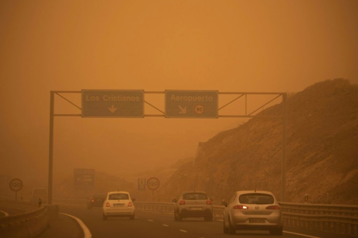 Cars drive on the TF-1 highway during a sandstorm in Santa Cruz de Tenerife, Spain, on February 23, 2020; airports on Spain's Canary Islands were closed after strong winds carrying red sand from the Sahara shrouded the tourist hotspot