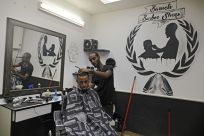 Israeli Ethiopian Jewish hairdresser Baruch works at his barbershop in the southern Israeli city of Ashkelon. Israel's 140,000-strong Ethiopian-Israeli community could  prove pivotal in the Jewish state's tight March 2 election.