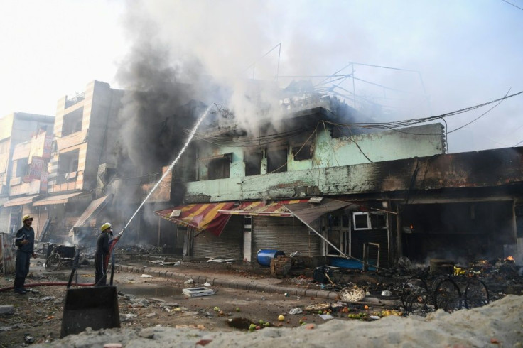 Several buildings were torched in clashes between supporters and opponents of a controversial new Indian citizenship law
