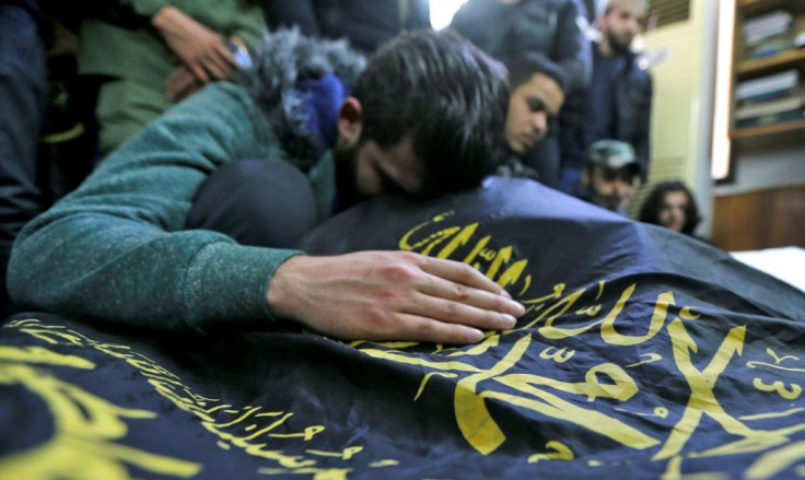 Relatives of the Islamic Jihad militants killed overnight mourn at a mosque in the Palestinian refugee camp of Yarmuk, near Damascus
