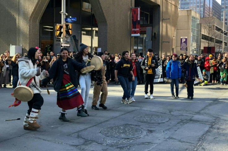 Protesters dance through the streets of Ottawa, Canada on February 24, 2020 in support of a small group fighting construction of a natural gas pipeline on indigenous lands in British Columbia