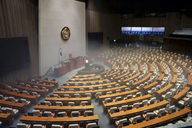 Workers from the Korea Pest Control Association sprayed disinfectant at the National Assembly in Seoul